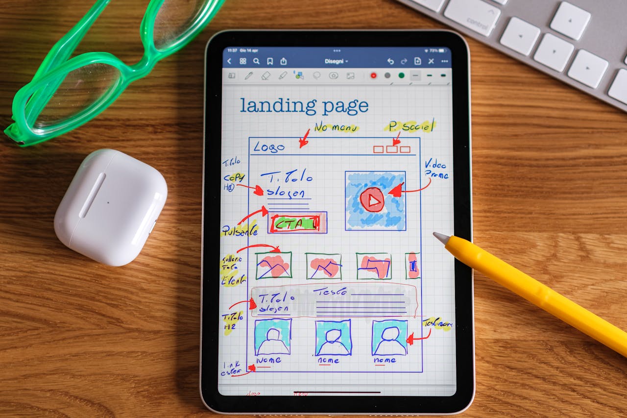 Services Close-up of tablet showing a hand-drawn landing page design, ideal for web development concepts.